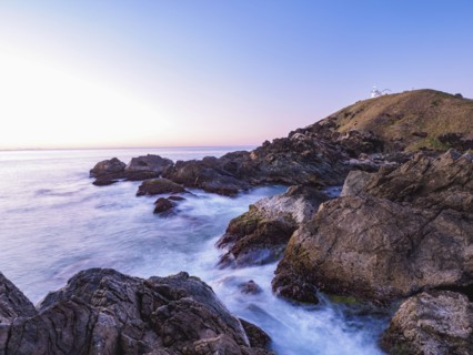 Australia, New South Wales, Port Macquarie, Lighthouse on rocky coat at sunrise