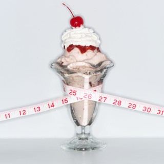 Ice cream sundae wrapped with tape measure.