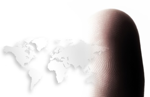 World map outline and human finger.