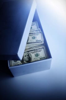 100 dollar bills in blue cardboard box.
