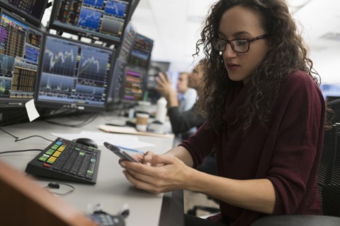 Young trader using mobile phone.
