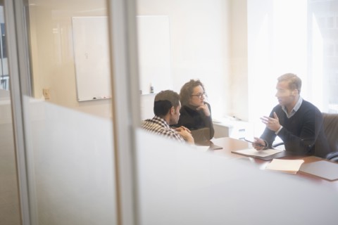 Young business people having meeting in board room.