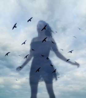 Multiple layered image of young woman against sky.
