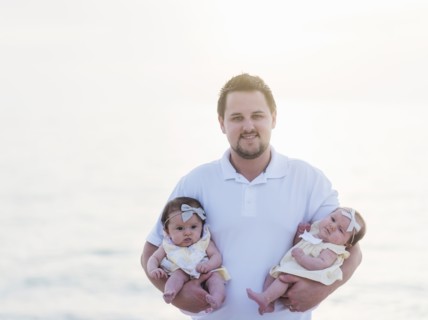 Happy father holding babies (2-5 months)
