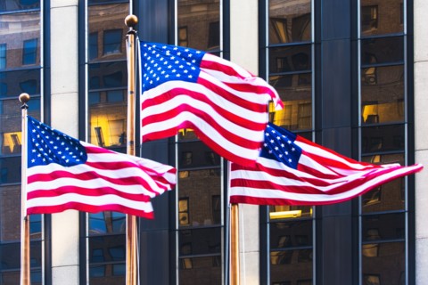 USA, New York, American flags in front of office building
