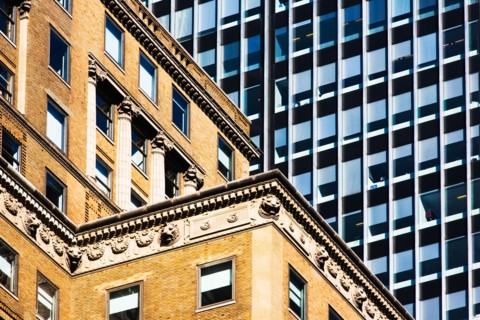 USA, New York, Old building and modern office block behind