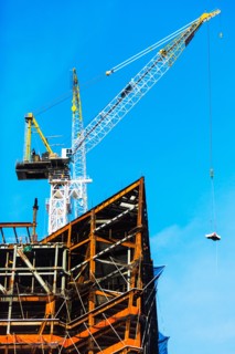 Crane at construction site against clear sky