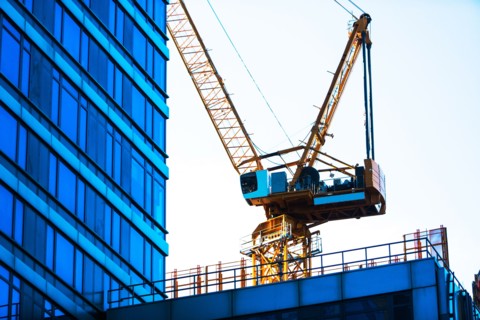 USA, New York, New York City, Crane with office building in foreground
