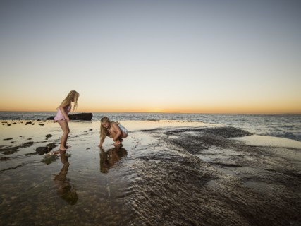 Girls (6-7,8-9) playing on beach