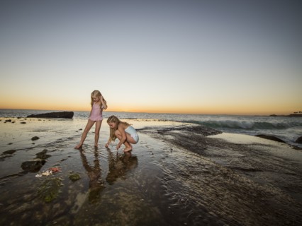 Girls (6-7,8-9) playing on beach