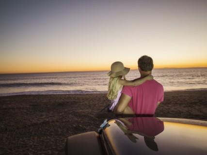 Father and daughter (4-5) looking at sea