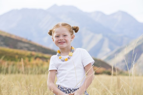 USA, Utah, Provo, Girl (4-5) standing in field