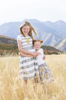 USA, Utah, Provo, Two girls (4-5, 8-9) standing in field