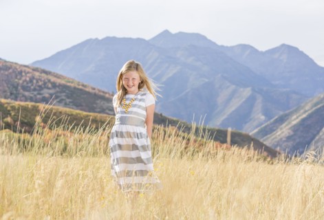 USA, Utah, Provo, Girl (8-9) standing in field