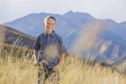 USA, Utah, Provo, Boy (6-7) standing in field