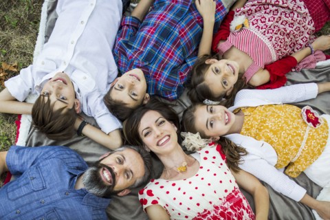 Family lying on grass