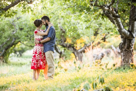Couple embracing in cherry orchard