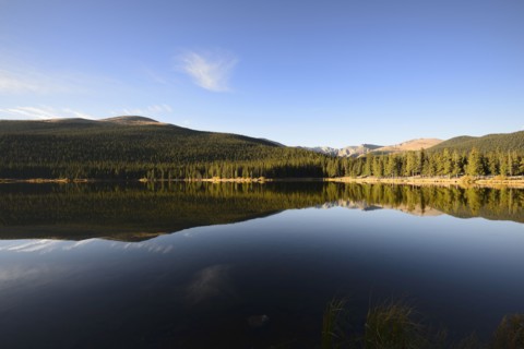 USA, Colorado, Mount Evans and forest reflecting in Echo Lake