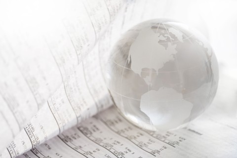 Financial newspaper with crystal ball.