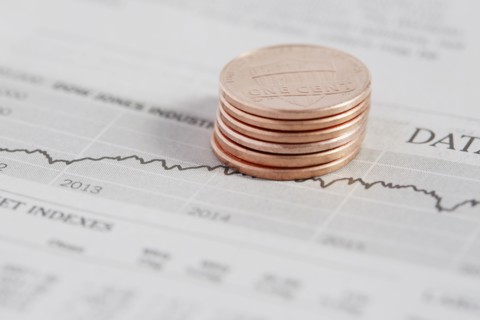 Stack of coins on stock market data