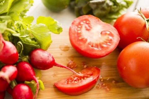 Tomato and radish on cutting board