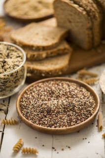 Quinoa in bowl and sliced brown bread in background