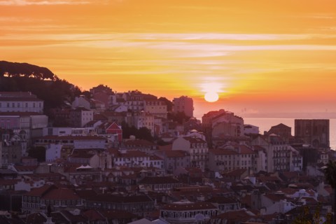Portugal, Lisbon, Sun rising above Old Town of Lisbon