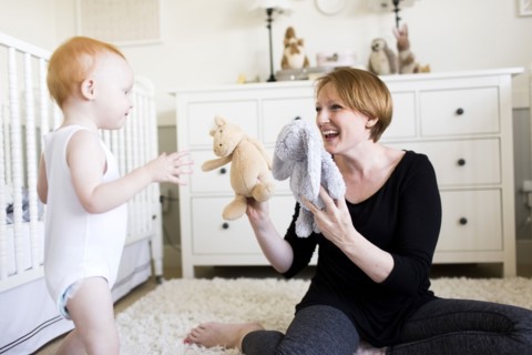 Mother playing with son (12-17 months) in nursery