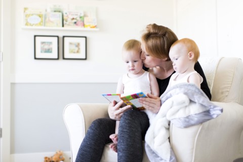 Mother and sons (12-17 months) reading picture book