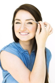 Woman plucking eyebrows