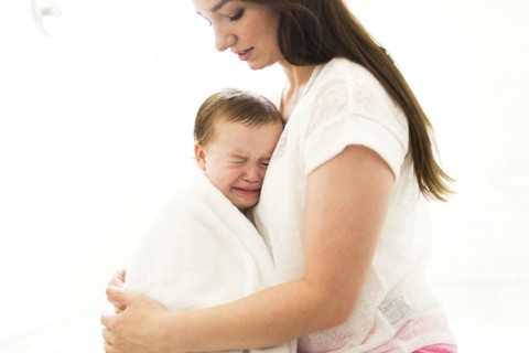 Mother embracing and consoling son (4-5)