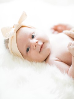 Portrait of girl (0-1 months) with ribbon on head