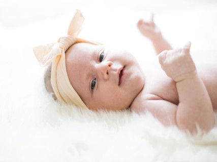 Portrait of girl (0-1 months) with ribbon on head