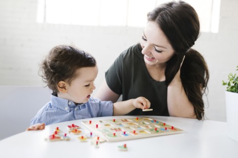 Mother playing alphabet game with son (4-5)