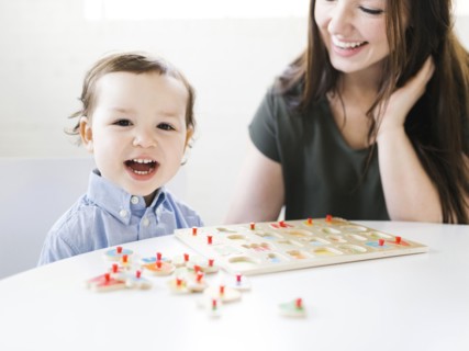 Mother playing alphabet game with son (4-5)