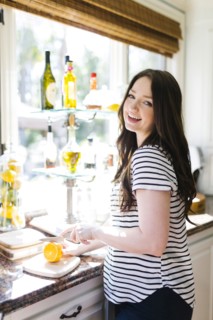 Woman cutting lemon in kitchen