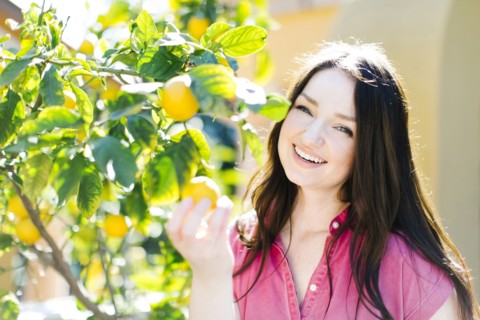 Woman picking oranges