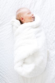 Baby boy (2-5 months) sleeping in white blanket