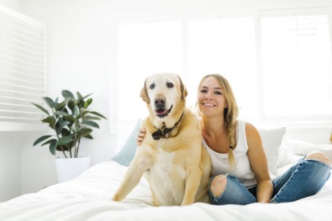 Portrait of blond woman with golden retriever