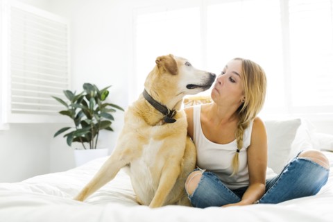 Portrait of blond woman with golden retriever