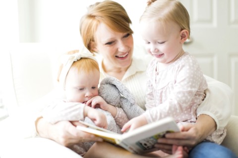 Mother reading book to daughters ( 12-17 months )