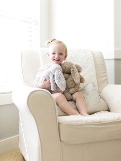 Portrait of girl ( 12-17 months ) holding stuffed toys