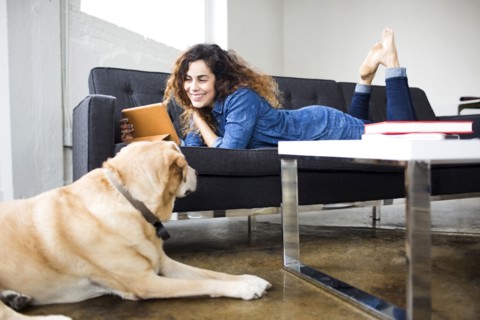 Woman watching tablet on sofa