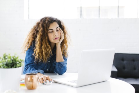 Woman using laptop at table