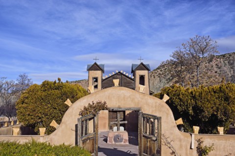 USA, New Mexico, Chimayo, El Santuario de Chimayo among trees and mountains