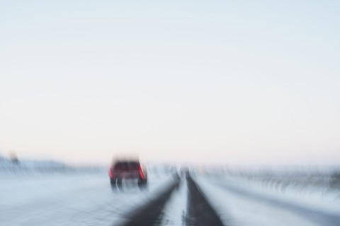 USA, New Mexico, Car on snowy highway