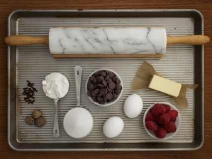 Studio shot of baking sheet with rolling pin and fresh ingredients