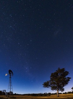 Australia, Canberra, Starry sky over rural landscape
