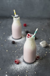 Studio shot of raspberry milkshake in bottles