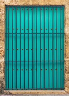 Cuba, Havana, Building exterior with turquoise shutters